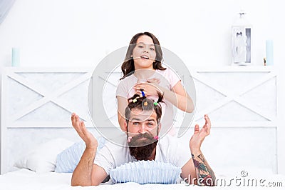 Free time. togetherness. spending time together at home. little girl made funny hairstyle for daddy. daughter and dad Stock Photo