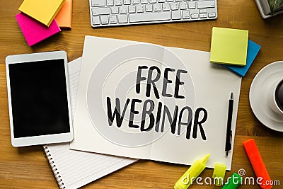 FREE WEBINAR on the tablet pc screen and by businessman hands - Stock Photo