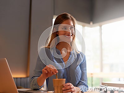 Free wifi and great coffee. an attractive young woman blogging in her local coffee shop. Stock Photo