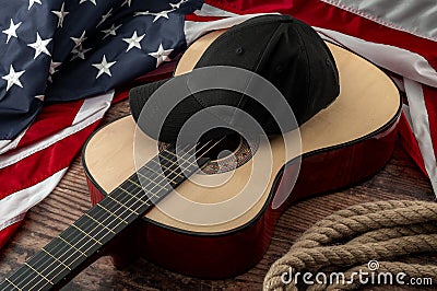 Freedom and american country and blues music festival concept with USA flag and acoustic guitar with a black cap on top and cowboy Stock Photo