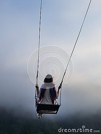 Freedom and carefree of a young female on a swing Stock Photo