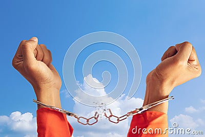 Freedom concept. two hands of prisoner with broken handcuff for freedom meaning with blue sky at background Stock Photo