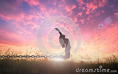 Freedom concept of woman jumping and broken chains Stock Photo