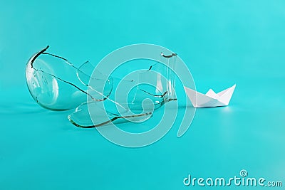 Freedom and dreams concept. Broken cage, free flight. Paper ship broke jar. Isolated on blue background. Copy space Stock Photo
