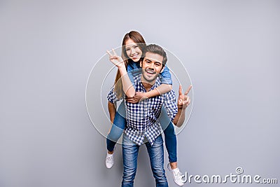 Freedom and fun, emotions and feelings. Cheerful and playful couple in casual outfits are fooling around, gesturing peace Stock Photo