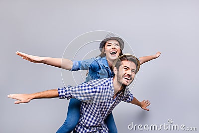 Freedom and fun, emotions and feelings. Cheerful and playful couple in casual outfits and hats are fooling around, gesturing plan Stock Photo