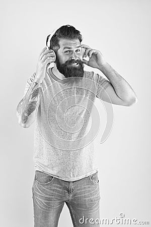 Freedom going wireless offers you is unparalleled. Hipster happy using modern wireless headphones. Wireless headphones Stock Photo