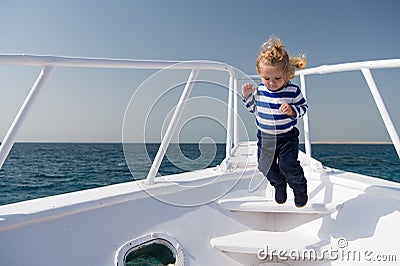 Freedom and joy. Adventure boy sailor travelling sea. Child cute sailor carefree jump yacht bow. Boy adorable sailor Stock Photo