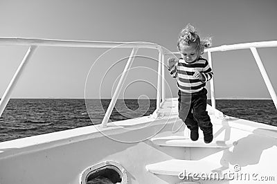 Freedom and joy. Adventure boy sailor travelling sea. Child cute sailor carefree jump yacht bow. Boy adorable sailor Stock Photo