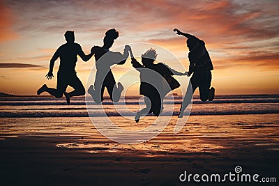 Freedom, jump and silhouette of friends at the beach and travel on brazil vacation for success, happy or motivation Stock Photo