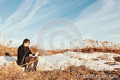 Freedom - Man using a laptop outdoor in park with copyspace Stock Photo