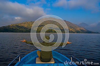 Freedom men siting on boad on river with hand up Stock Photo