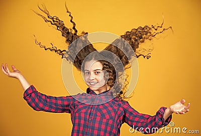 Freedom self expression. Small girl hairdresser salon. Brushing long hair. Little child curly hair. Fashion and beauty Stock Photo