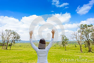 Woman lifting her hands up in the air another nice day Stock Photo