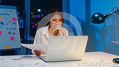 Freelance Asia women using laptop hard work in living room at house. Stock Photo