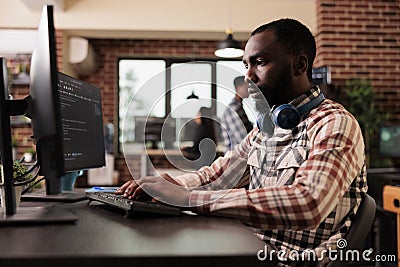 Freelance coder typing javascript code on computer Stock Photo