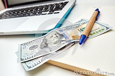 Freelance desktop with money and notepad Stock Photo