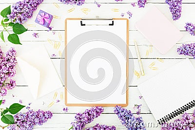 Freelancer or blogger concept. Minimalistic workspace with clipboard, envelope, pen, box, lilac and accessories on white backgroun Stock Photo