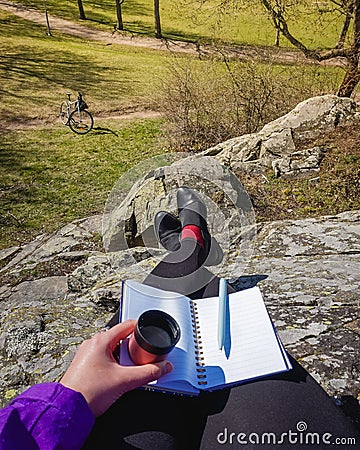 Freelancer freelance writer writing an article in a park Stock Photo