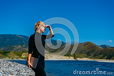 Freelancer with laptop on the nature. Blogger hipster traveler business lady pretty girl finished work outdoor. Young blondy Stock Photo