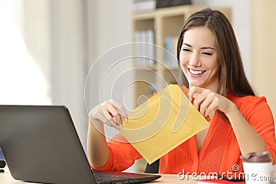 Freelancer opening a padded envelope Stock Photo