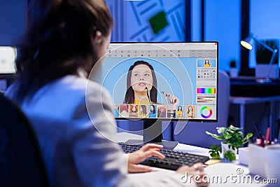 Freelancer retoucher woman working overtime on laptop computer Stock Photo
