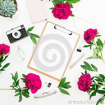 Freelancer workspace with clipboard, dairy, peony flowers, retro camera on white background. Flat lay, top view. Beauty blog conce Stock Photo