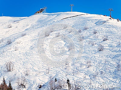 Freeride mountain slope with chair lift station at the top Stock Photo