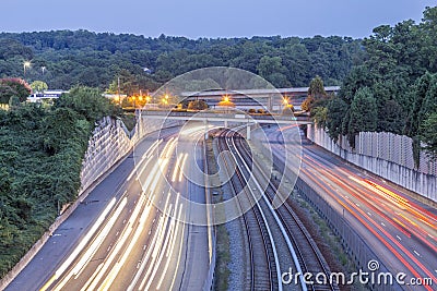 Freeway with train tracks Stock Photo