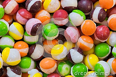 Freeze dried Skittles hard candy colorful macro with splits through their centers. Stock Photo