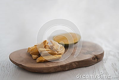 Freeze-dried mango with fresh one on olive wood board with copy space Stock Photo