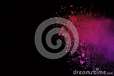 Freeze motion of colored powder explosion isolated on black background. Abstract of Multicolor dust splatted. Stock Photo