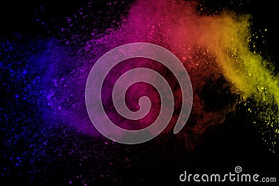 Freeze motion of colored powder explosion isolated on black background. Abstract of Multicolor dust splatted. Stock Photo