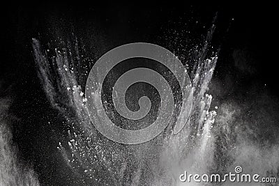 Freeze motion explosion of white dust on a black background. Stock Photo