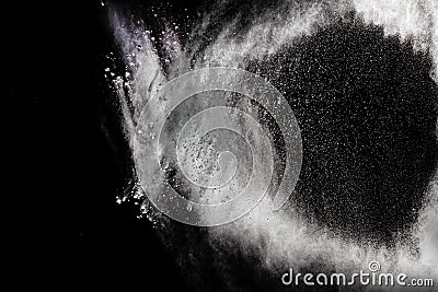 Freeze motion explosion of white dust on a black background. Stock Photo