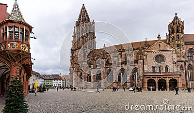 View of tourists visiting the cathedral and minster in Freiburg in the Breisgau Editorial Stock Photo