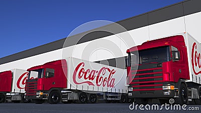 Freight semi trucks with Coca-Cola logo loading or unloading at warehouse dock. Editorial 3D rendering Editorial Stock Photo