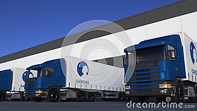 Freight semi trucks with Danone logo loading or unloading at warehouse dock. Editorial 3D rendering Editorial Stock Photo