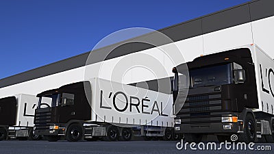 Freight semi trucks with L`Oreal logo loading or unloading at warehouse dock. Editorial 3D rendering Editorial Stock Photo