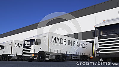 Freight semi trucks with MADE IN FRANCE caption on the trailer loading or unloading. Road cargo transportation 3D Stock Photo