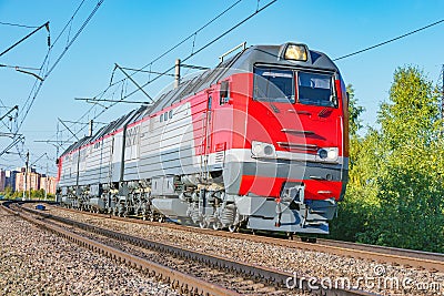 Freight three section diesel locomotive approaches to the station Stock Photo