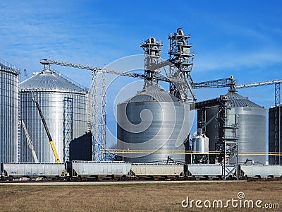 Freight train being loaded with grain for transpor Stock Photo