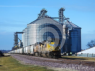 Freight train being loaded with grain for transport Stock Photo