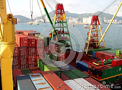 Freight vessel loading unloading in port terminal. Container ship with cranes in dock. Stock Photo