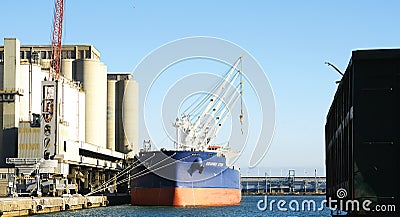 Freighter in the industrial area of the port of Barcelona Editorial Stock Photo