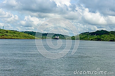 Freighter negotiating the Culebra cut on the Panama Canal Editorial Stock Photo