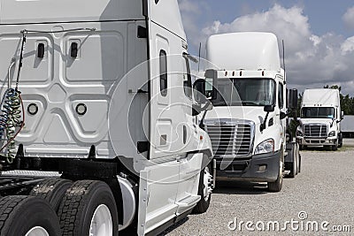 Freightliner Semi Tractor Trailer Trucks Lined up for sale. Freightliner is owned by Daimler Editorial Stock Photo