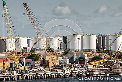 Fremantle, Australia - November 25. 2009: New dock under construction at the port. Many white petroleum tanks as background under Editorial Stock Photo