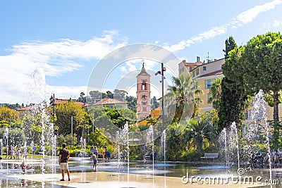 French adults and children play in the water fountain spray at the Paillon Promenade in the city of Nice, France Editorial Stock Photo