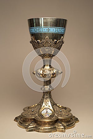 French antique Eucharist Mass Chalice Silver Gold plated with filigree and hand painted medallion of Crucifixion Latin text Stock Photo